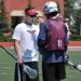 Lacrosse Head Coach Frank Clark with camp participant Connor Simpson of Eagan, Minn. on UMD's Griggs Field.