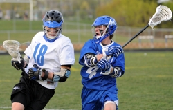 Eastview's Chris Granat, left, tries to turn the corner on Minnetonka's Teddy O'Reilly. Photo by Loren Nelson