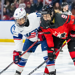 Team USA's #10 Becca Gilmore looks poised to play the puck at the face-off dot next to a Team Canada player