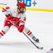Senior forward Casey O'Brien, wearing Wisconsin's white and red uniform, skates toward the goaltender
