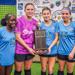 Minneapolis Roosevelt Girls Soccer players pose with the Stars of the Cities All Star Game trophy