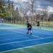 Minneapolis Roosevelt High School Teddy Boys tennis doubles players during a match at Folwell Park