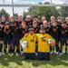 Image of Minneapolis Roosevelt High School’s boys varsity soccer team of 2025 grouped together with their coach for a team photo on the field at Al Gowans Stadium.