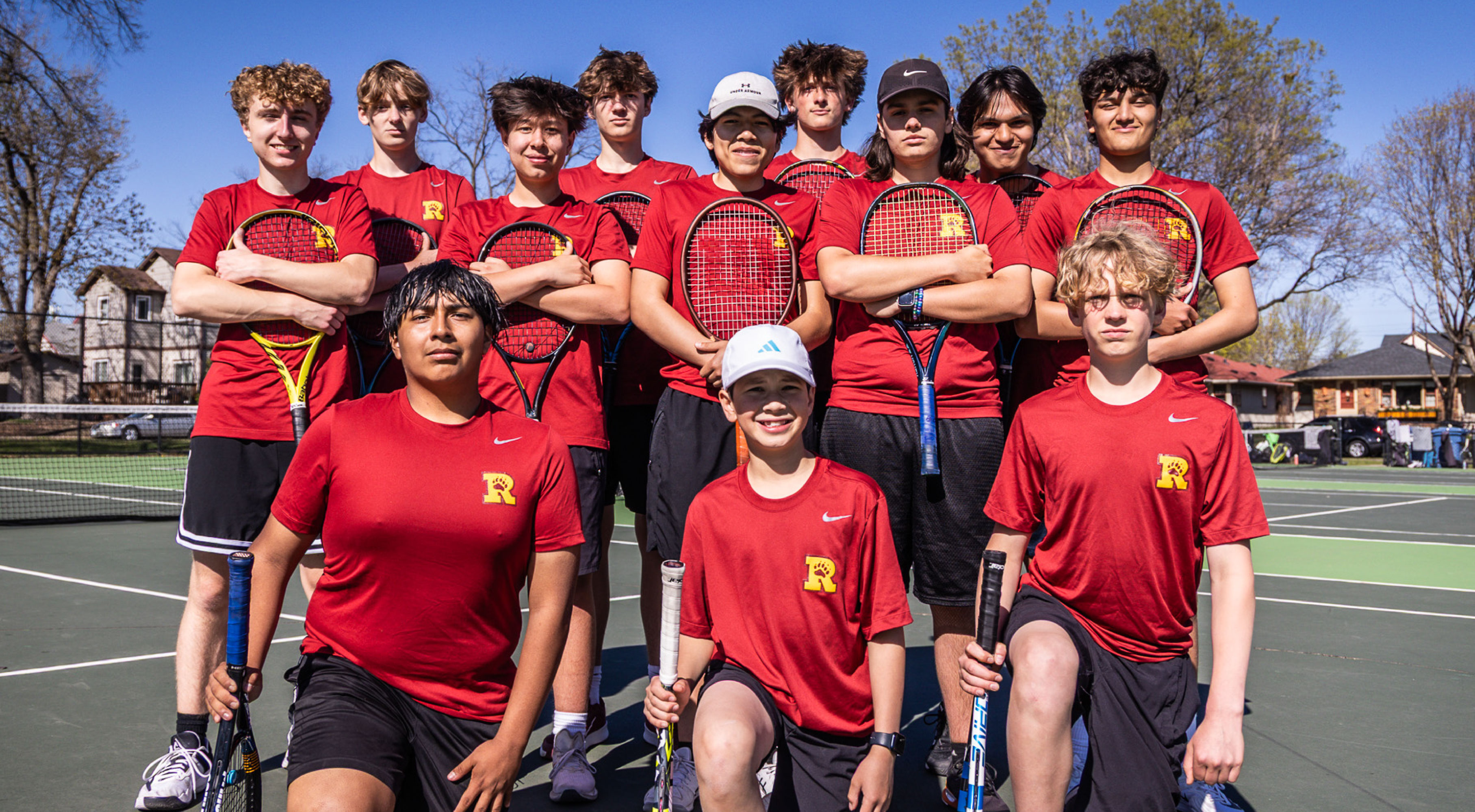 Minneapolis Roosevelt Teddies Varsity Boys Tennis team posing for a team picture at Lake Hiawatha tennis courts