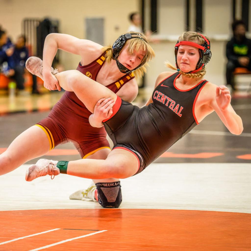 Minneapolis Roosevelt Wrestler Sam Hinman grabs her St Paul Central opponent’s leg while taking her down to the mat during a match