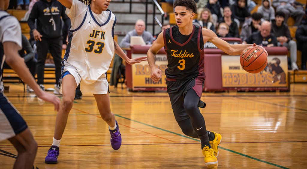Image of Minneapolis Roosevelt High School basketball boys driving past his opponent as he dribbles up court