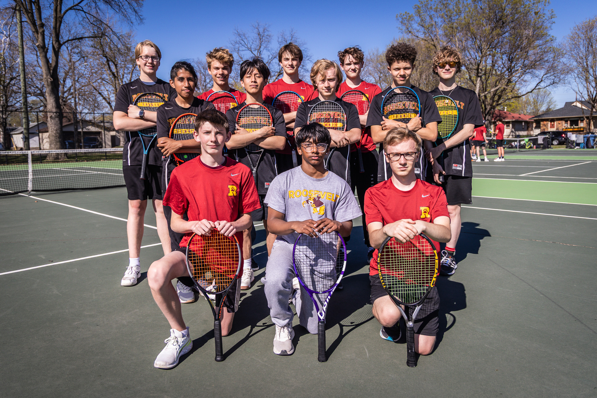 Minneapolis Roosevelt Teddies JV Boys Tennis team posing for a team picture at Lake Hiawatha tennis courts
