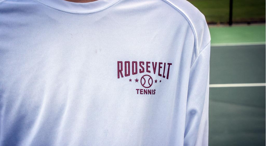 Close up image of Minneapolis Roosevelt Teddies High School Boys Tennis team warm up shirt with graphic: “Roosevelt Tennis”