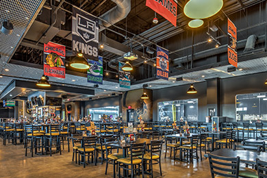 Tables and chairs inside Mackenzie River Pizza Pub & Grill